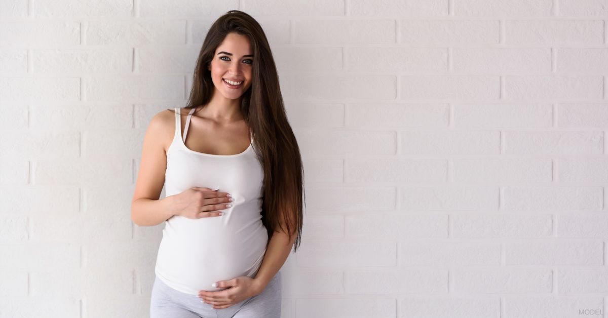 Pregnant woman smiling (MODEL)